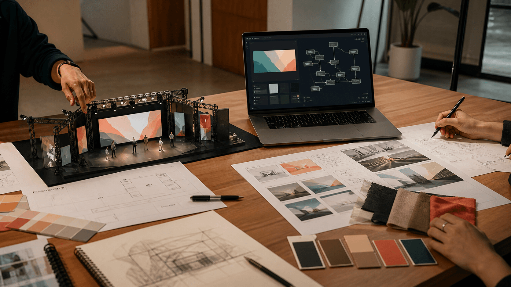 Event, creative, and technology artifacts meeting on one agency worktable